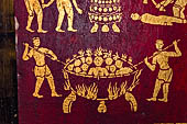 Luang Prabang, Laos - Wat Pa Phai the 'Bamboo Forest Monastery'. Inside gilded stencils against a red lacquered background depict scenes from the Buddhist hell.